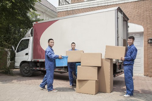 Professional movers unpacking items in a Catford home or office