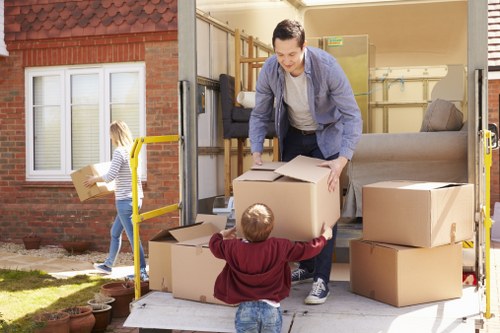 Local removals team planning a move in Catford with packed boxes and furniture