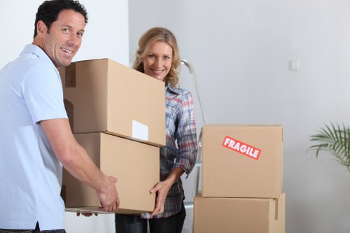 Prepared removals team organising wrapped furniture for transport in Catford